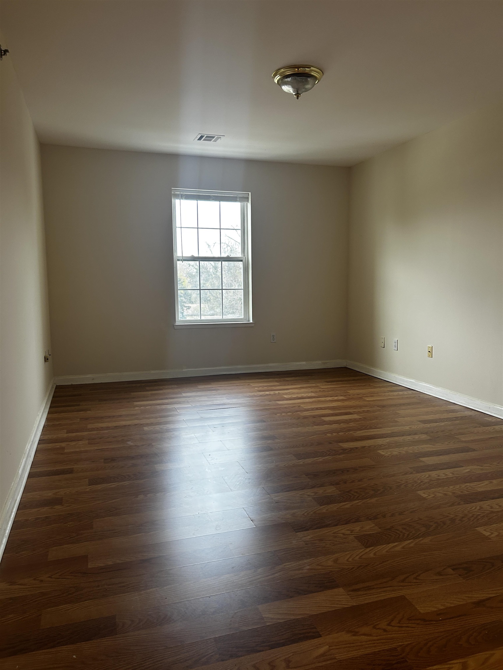 1609 West Lake Avenue, Unit 112 Neptune, NJ 07753 - Photo 4 of 12 wooden floor in an empty room with a window