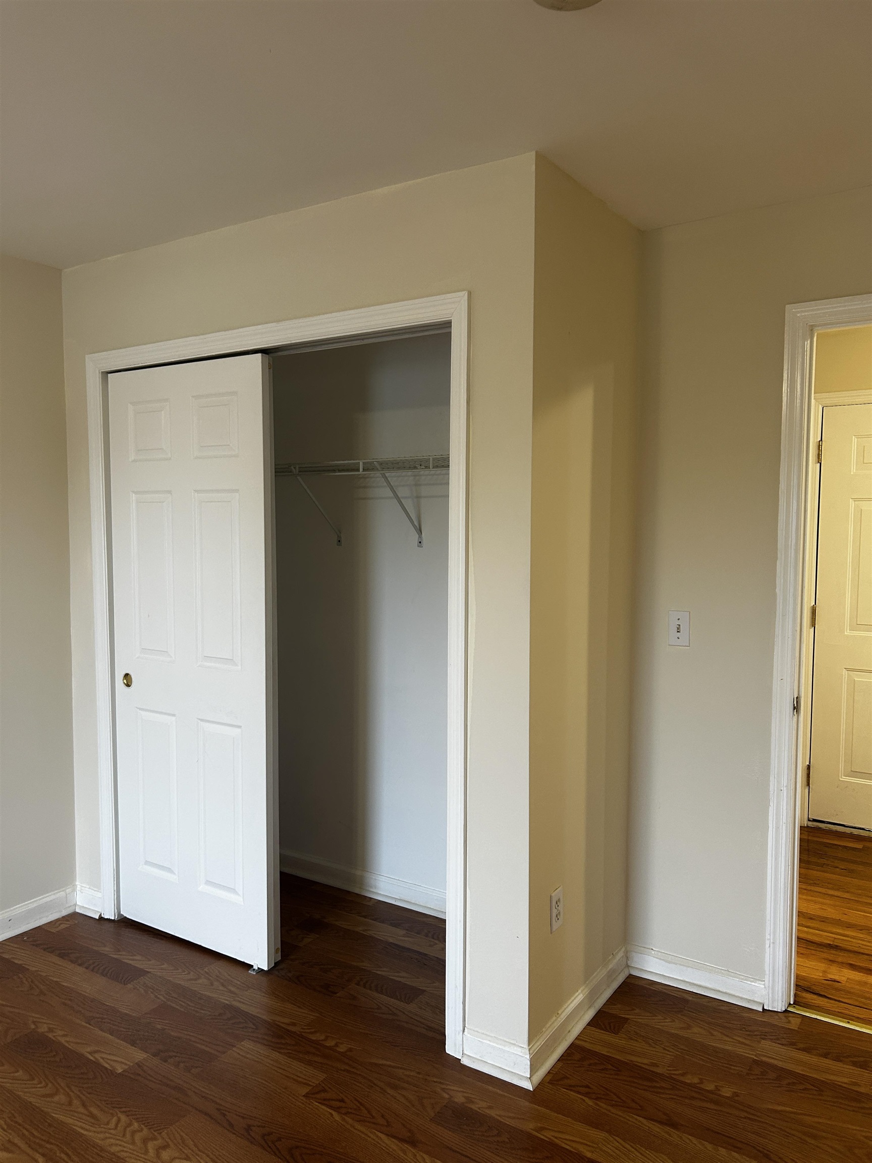 1609 West Lake Avenue, Unit 112 Neptune, NJ 07753 - Photo 8 of 12 a view of an empty room with wooden floor and closet