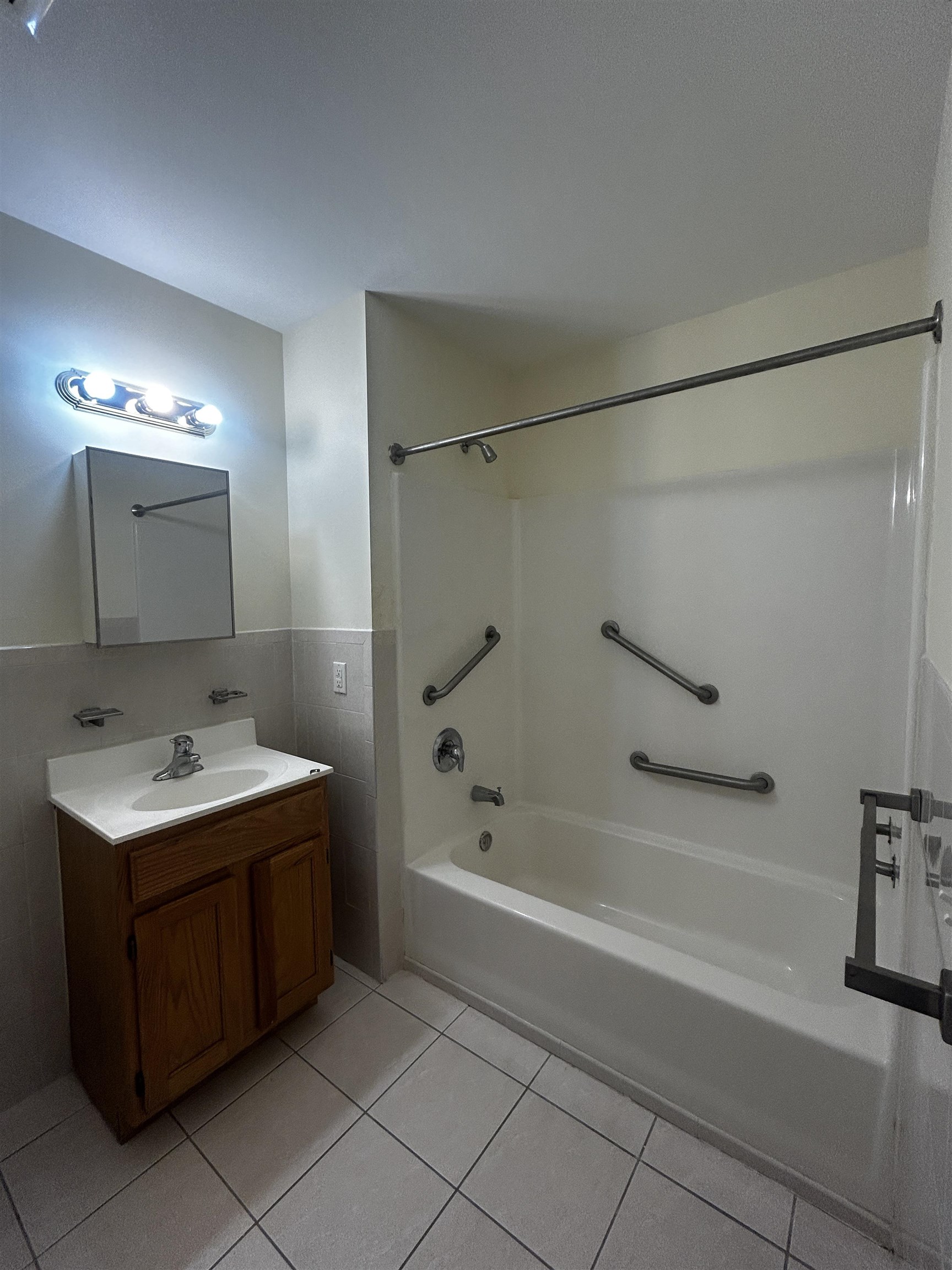 1609 West Lake Avenue, Unit 112 Neptune, NJ 07753 - Photo 10 of 12 a bathroom with a tub sink and mirror