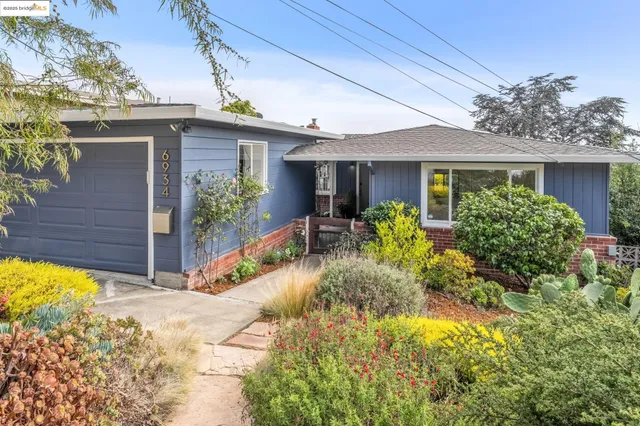 a view of a house with sitting area and garden
