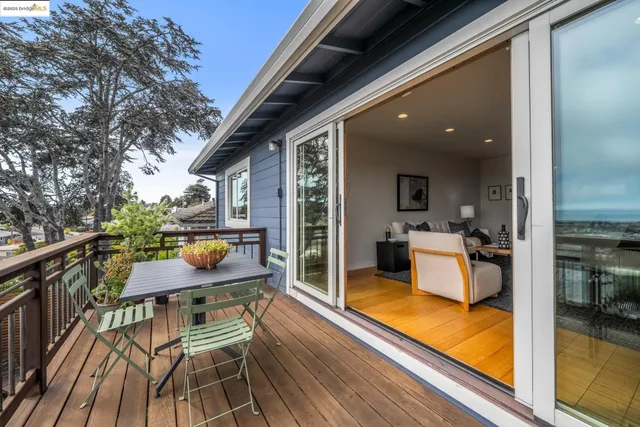 a view of a dining room with furniture large windows and wooden floor