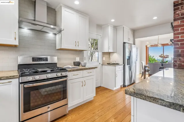 a kitchen with cabinets appliances a sink and a window