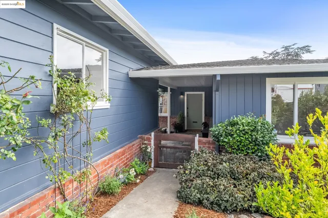 a backyard of a house with outdoor seating