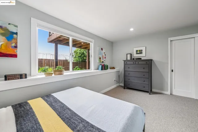 a bedroom with furniture and a rug