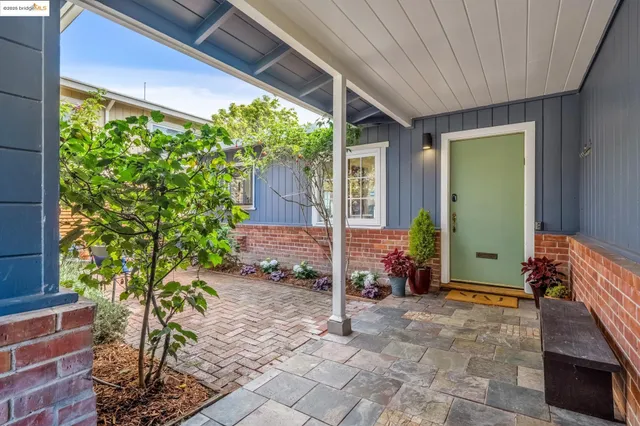 a view of chair and table in back yard of a house
