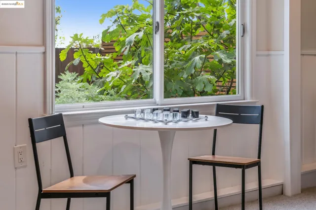 a view of a chair and table in backyard of the house