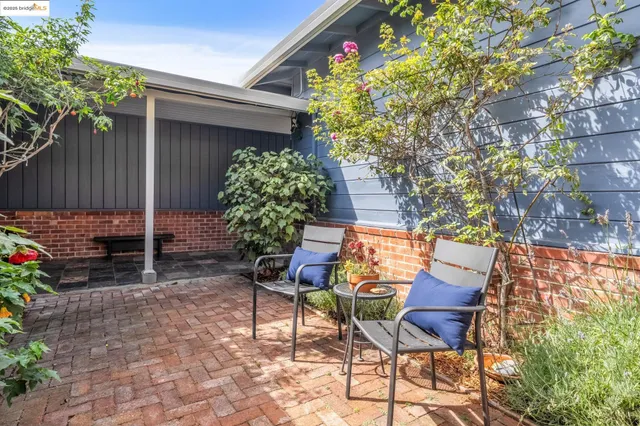 a living room with furniture fireplace and a large window
