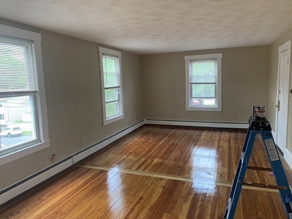1409 Worcester Street Springfield, MA 01151 - Photo 8 of 12 a view of an empty room with wooden floor and a window