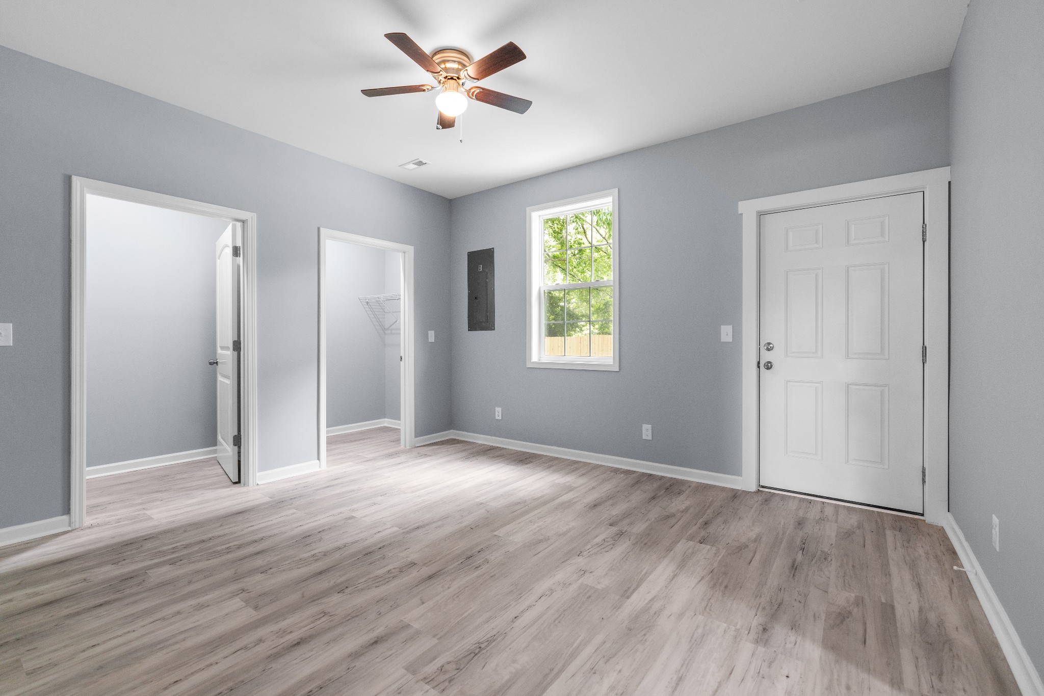 115 Freeman Street, Unit A Tullahoma, TN 37388 - Photo 14 of 25 an empty room with wooden floor and windows