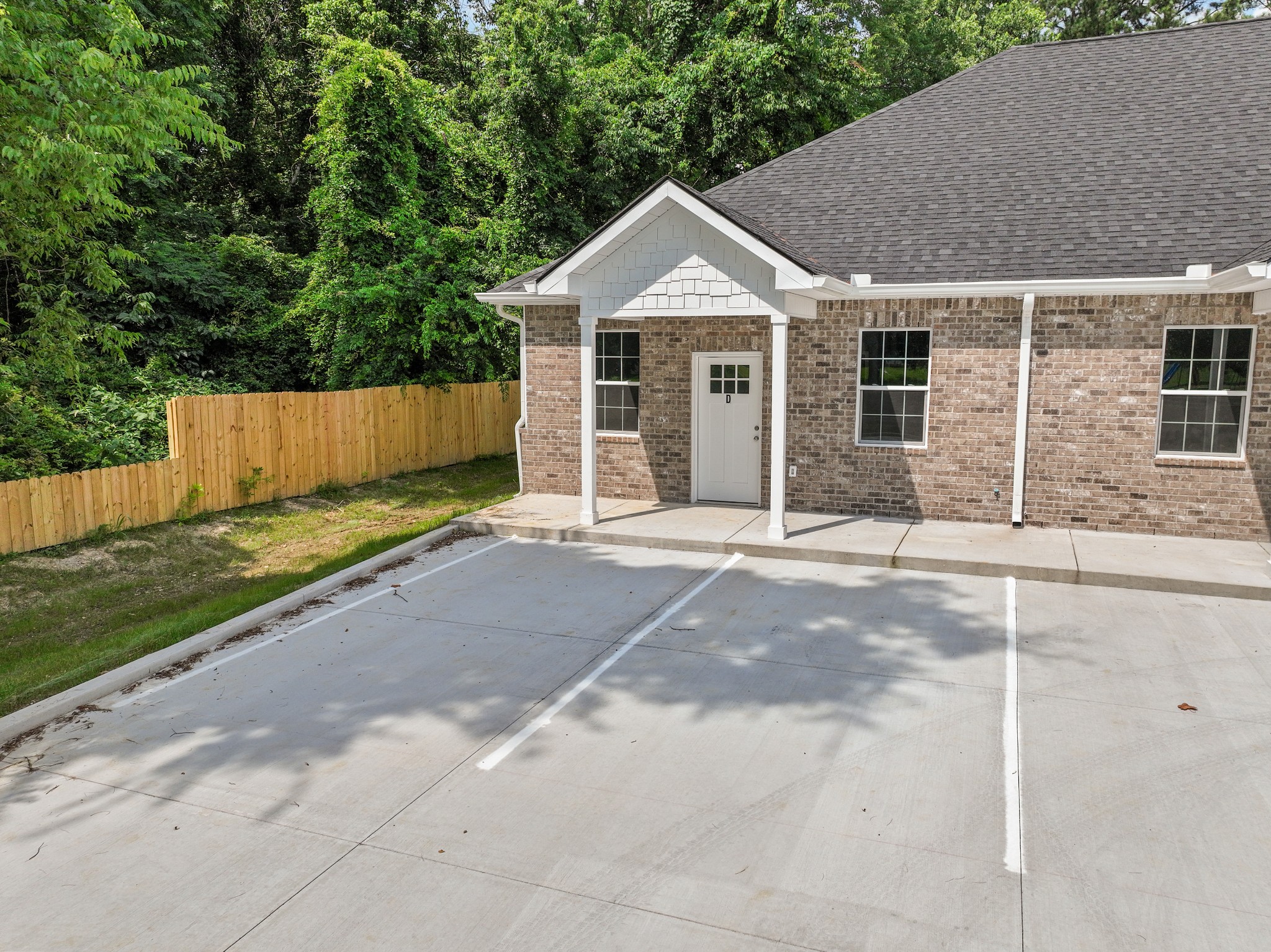 115 Freeman Street, Unit A Tullahoma, TN 37388 - Photo 2 of 25 a front view of a house with a yard and garage