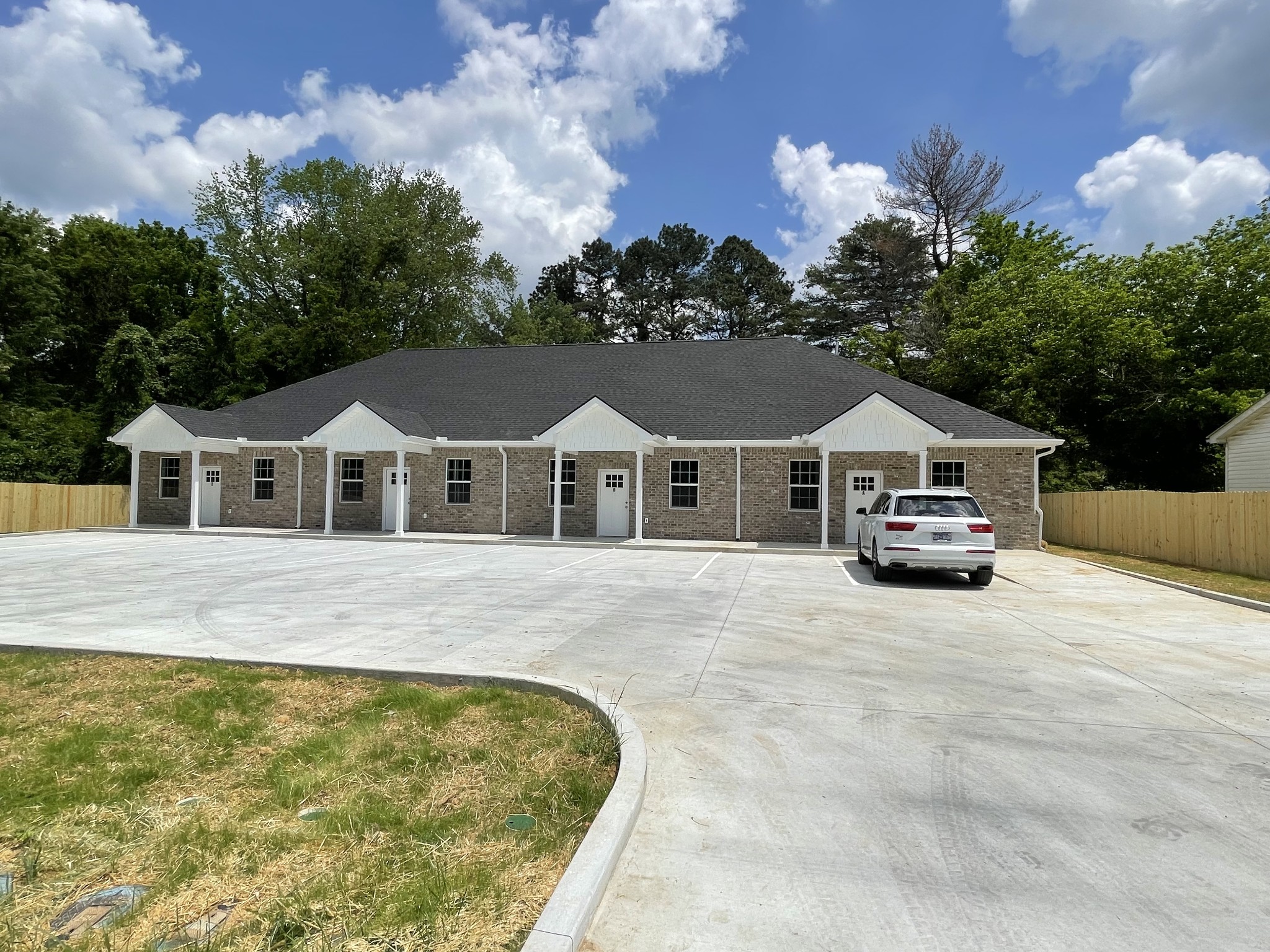 115 Freeman Street, Unit A Tullahoma, TN 37388 - Photo 21 of 25 a front view of a house with a yard and garage