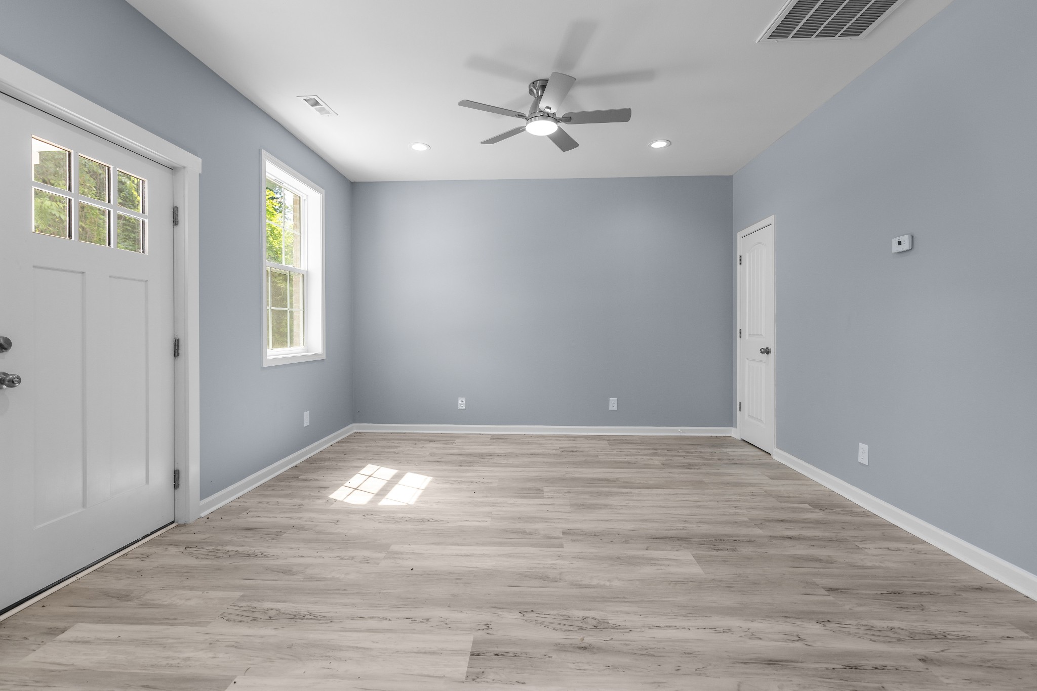 115 Freeman Street, Unit A Tullahoma, TN 37388 - Photo 5 of 25 a view of an empty room with window and wooden floor