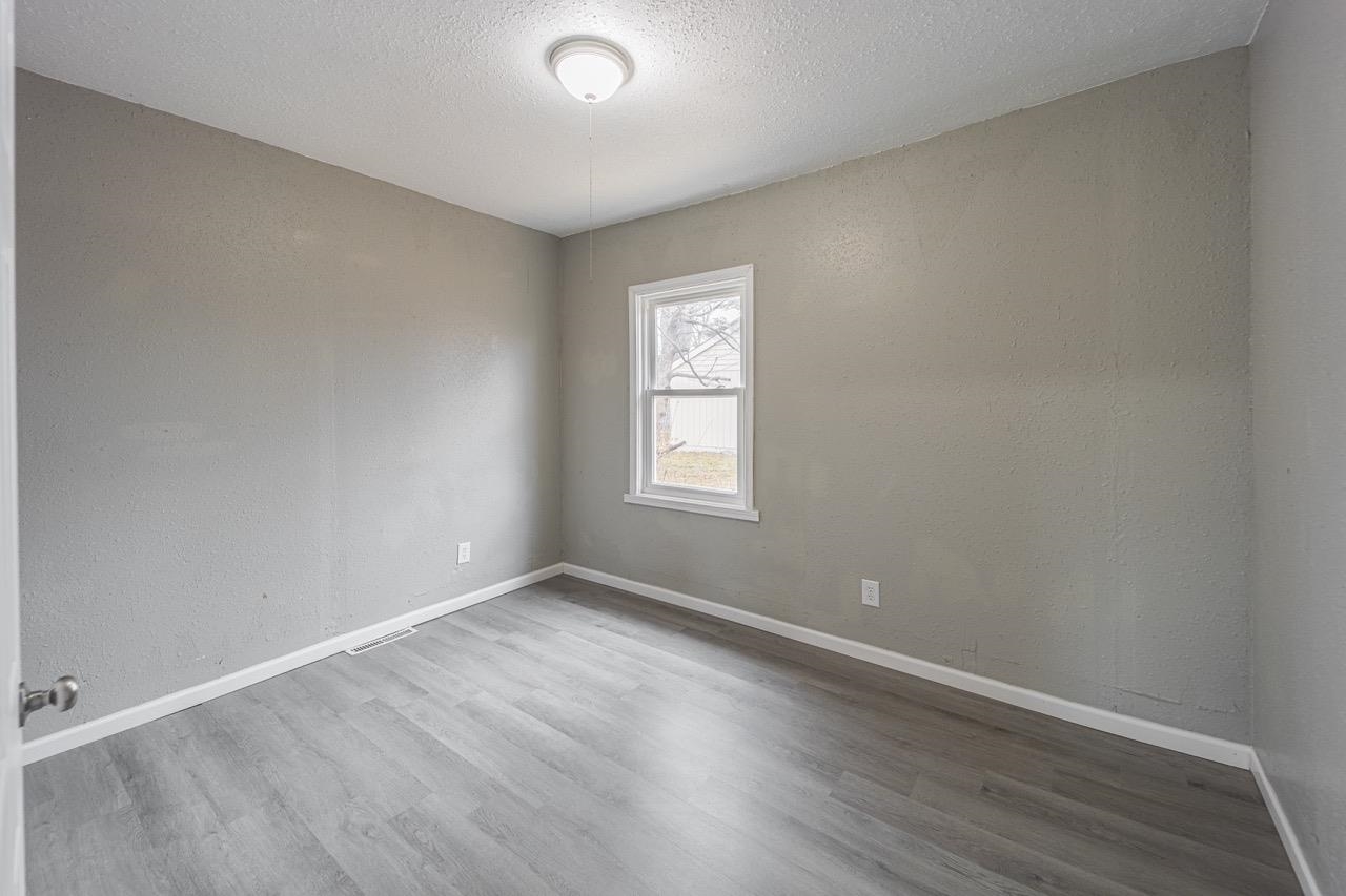 11783 Genessee Street Rockton, IL 61072 - Photo 12 of 31 an empty room with wooden floor and windows