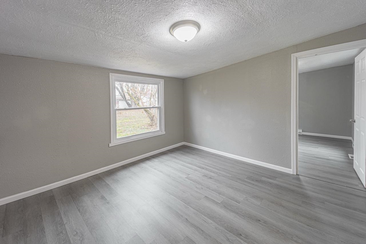 11783 Genessee Street Rockton, IL 61072 - Photo 21 of 31 an empty room with wooden floor and windows