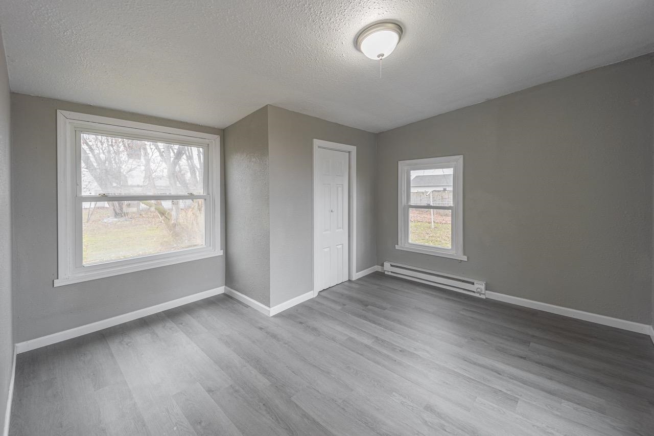 11783 Genessee Street Rockton, IL 61072 - Photo 23 of 31 an empty room with wooden floor and windows