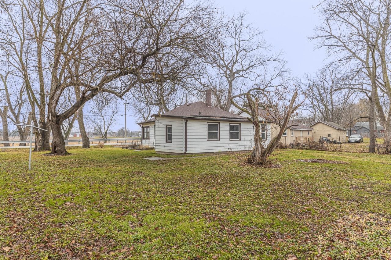 11783 Genessee Street Rockton, IL 61072 - Photo 7 of 31 a backyard of a house with large trees and outdoor seating