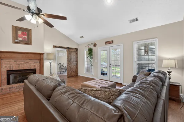 a view of a patio with couple of chairs and a potted plant