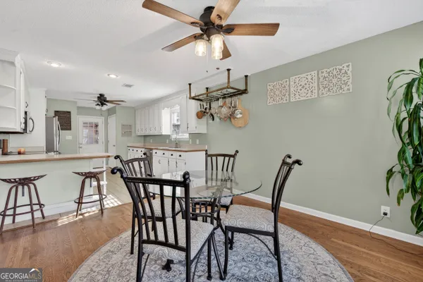 a front view of a house with garden and trees