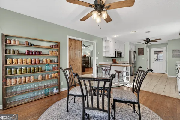 a view of a house with a big yard and large trees