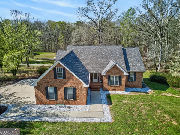 a living room with furniture large window and a fireplace