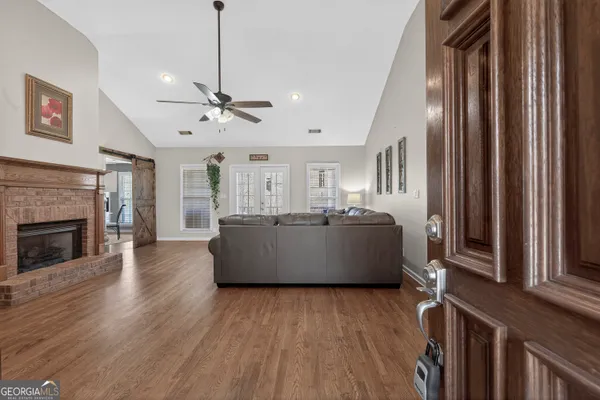 a bedroom with a large bed and a chandelier fan
