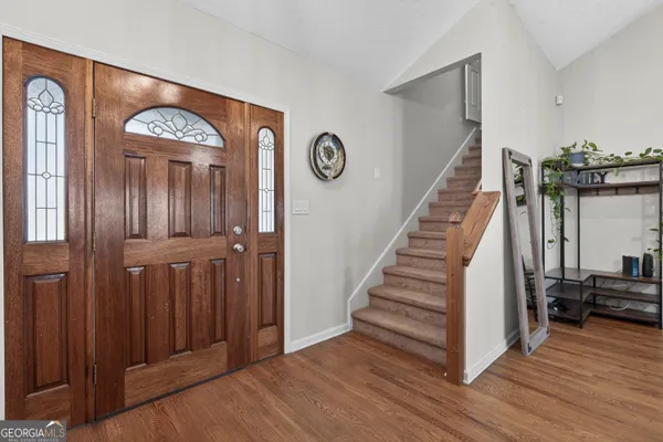 a bedroom with a bed and a chandelier fan