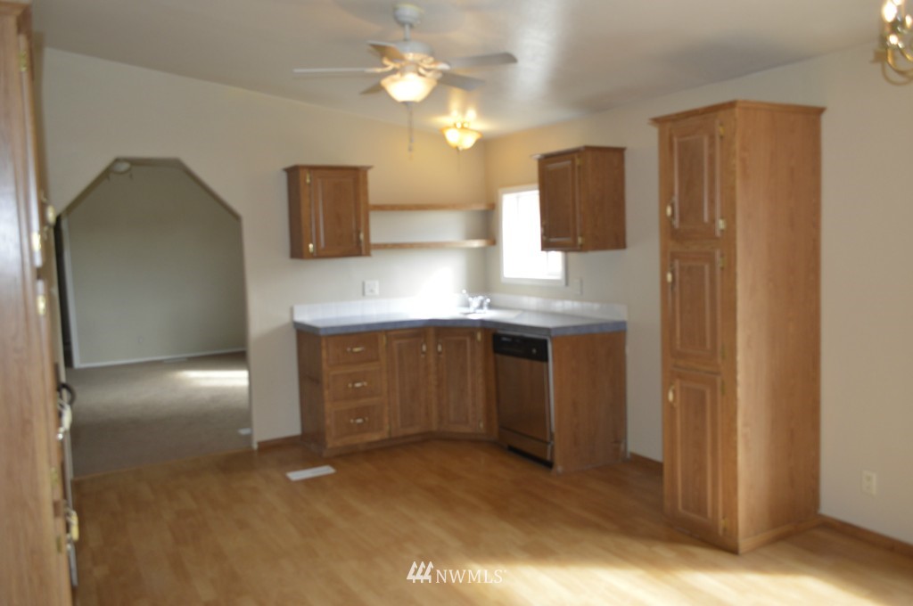 7112 187th Avenue Southwest Rochester, WA 98579 - Photo 5 of 19 a kitchen with a sink and refrigerator