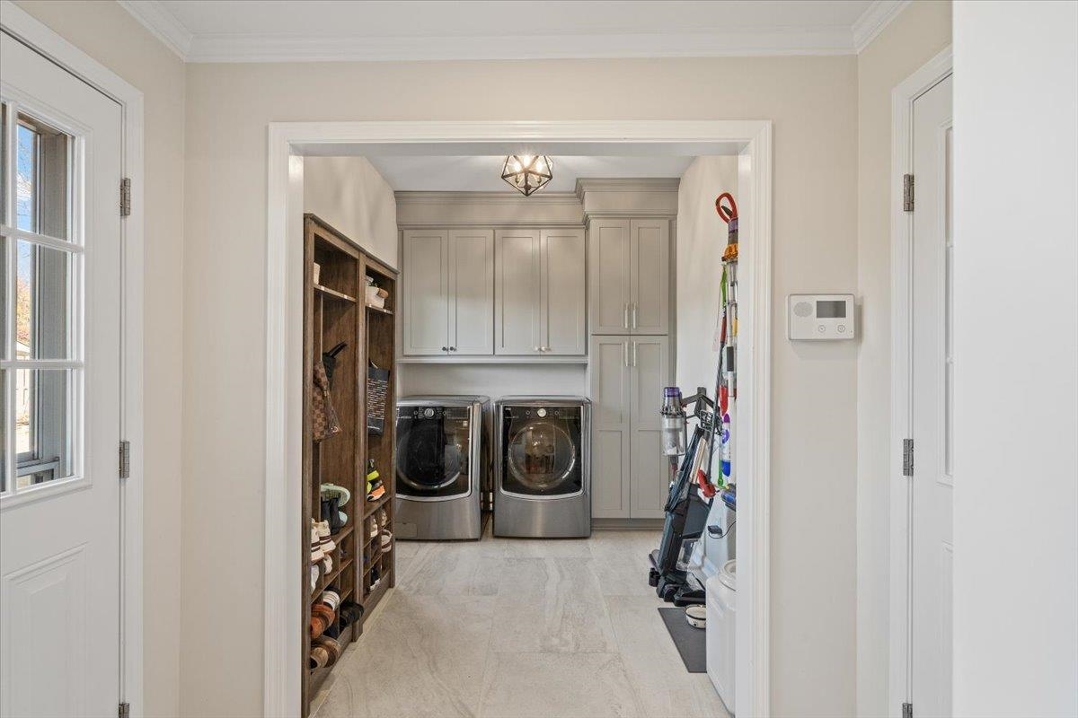 621 Fox Lair Cove Collierville, TN 38017 - Photo 25 of 37 Washroom with cabinet space, washer and dryer, and crown molding