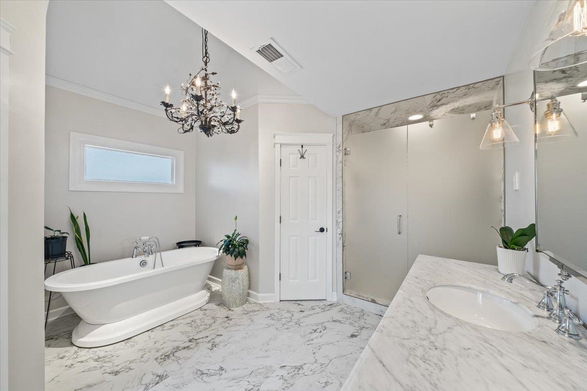 621 Fox Lair Cove Collierville, TN 38017 - Photo 29 of 37 a spacious bathroom with a double vanity sink a large mirror and a shower
