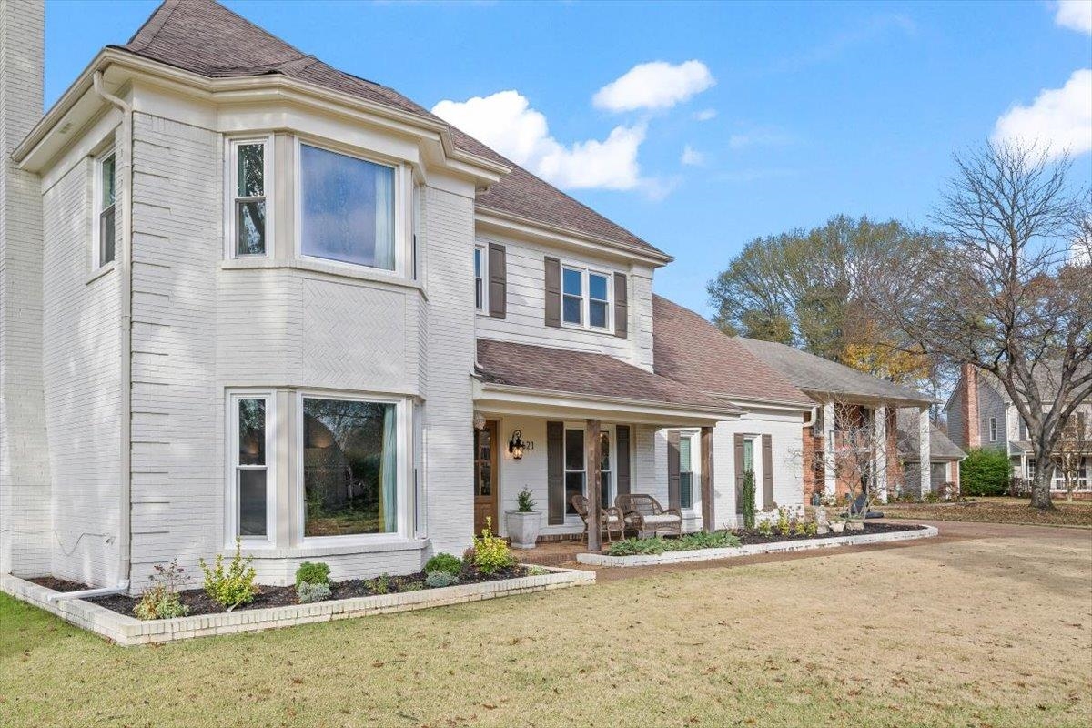 621 Fox Lair Cove Collierville, TN 38017 - Photo 3 of 37 View of front of home with covered porch, a front yard, and roof with shingles