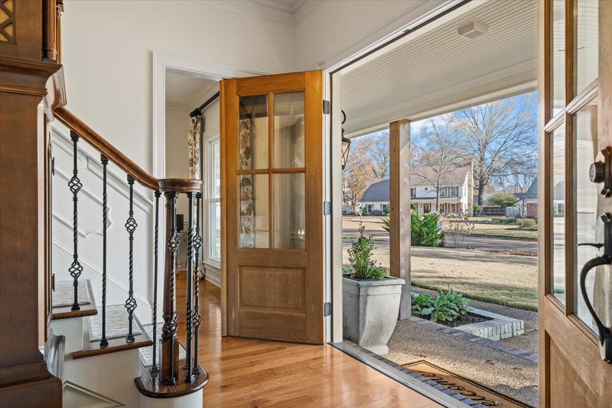 621 Fox Lair Cove Collierville, TN 38017 - Photo 7 of 37 Foyer featuring ornamental molding, light wood finished floors, stairs, and a decorative wall