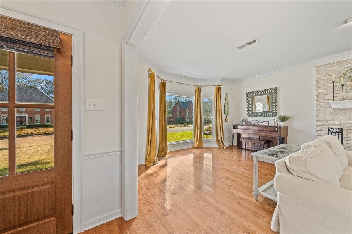 621 Fox Lair Cove Collierville, TN 38017 - Photo 8 of 37 a living room with furniture a flat screen tv and floor to ceiling window