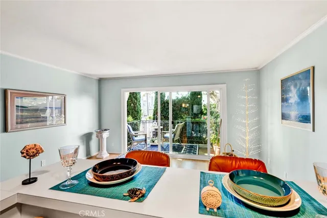 a kitchen with stainless steel appliances granite countertop a table chairs and a refrigerator