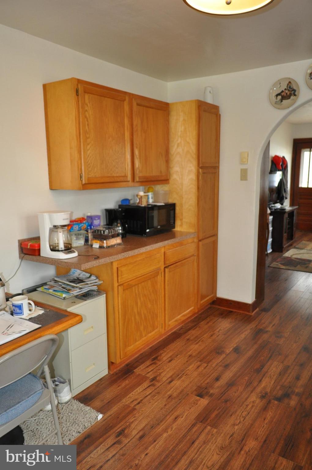 205 East 7th Avenue Ranson, WV 25438 - Photo 18 of 29 a kitchen with stainless steel appliances a stove a sink cabinets and wooden floor