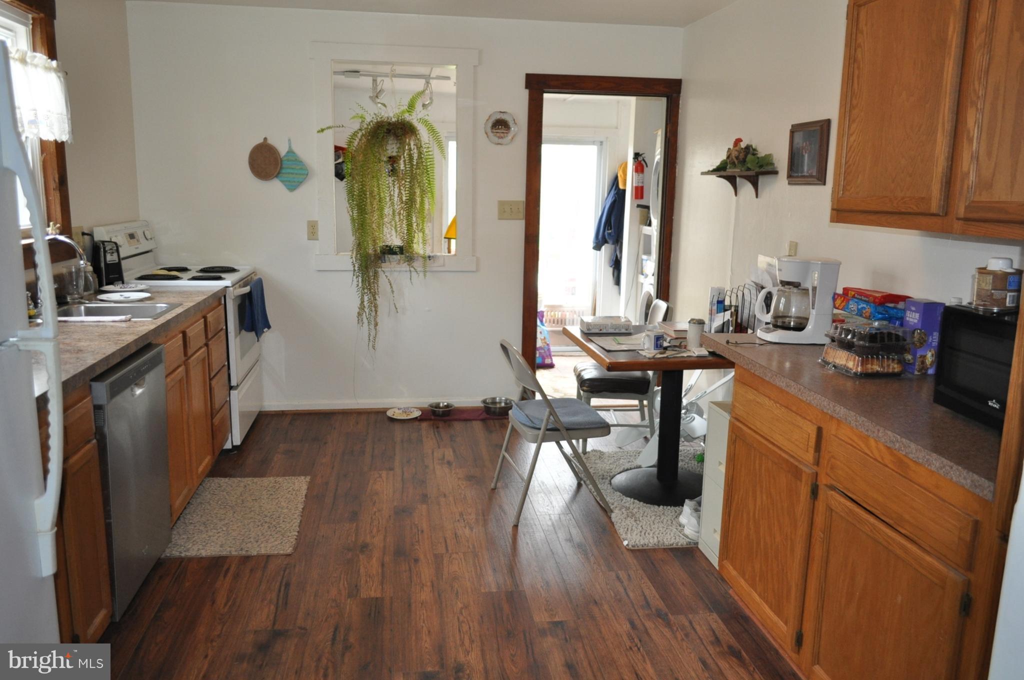 205 East 7th Avenue Ranson, WV 25438 - Photo 23 of 29 a kitchen with sink cabinets and wooden floor