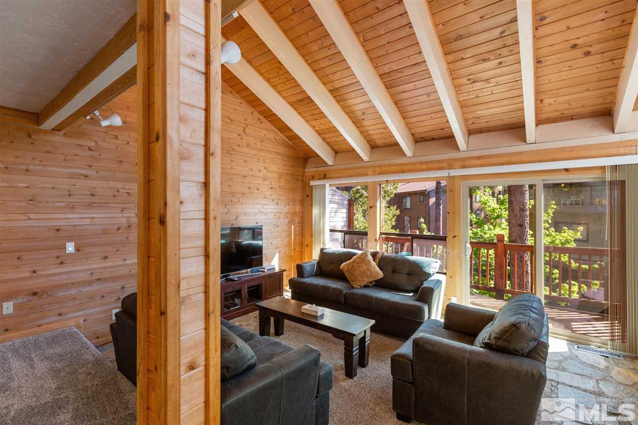 116 B Snowbird Court, Unit B Stateline, NV 89449 - Photo 11 of 40 a living room with furniture and floor to ceiling windows