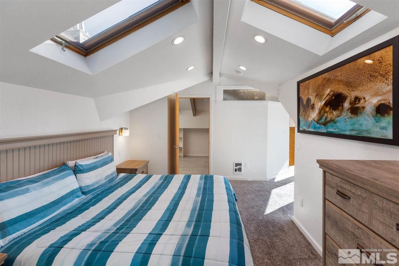116 B Snowbird Court, Unit B Stateline, NV 89449 - Photo 14 of 40 a spacious bedroom with a bed and painting on the wall