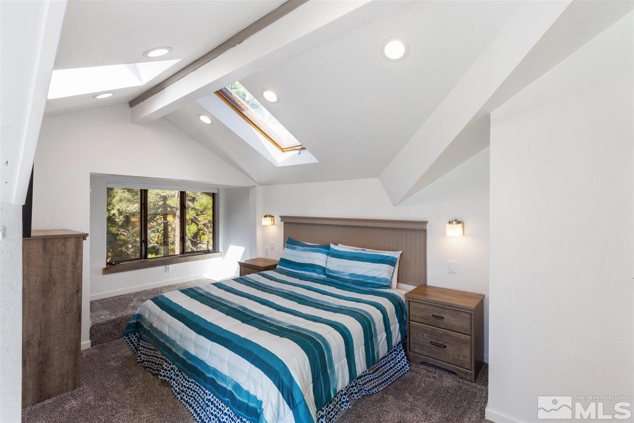116 B Snowbird Court, Unit B Stateline, NV 89449 - Photo 16 of 40 a bedroom with a large bed and a large window