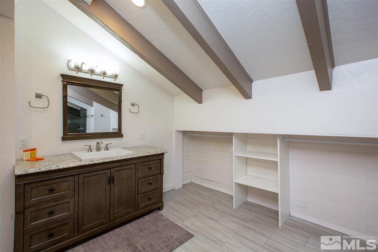 116 B Snowbird Court, Unit B Stateline, NV 89449 - Photo 19 of 40 a bathroom with a double vanity sink and a mirror
