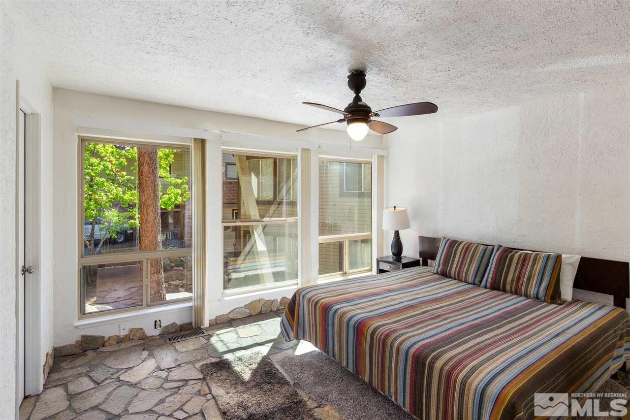 116 B Snowbird Court, Unit B Stateline, NV 89449 - Photo 23 of 40 a bedroom with a large bed and a large window