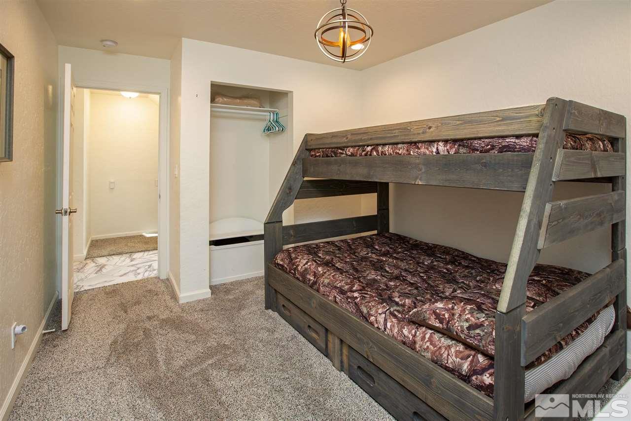 116 B Snowbird Court, Unit B Stateline, NV 89449 - Photo 27 of 40 a bedroom with a bed and a large mirror on the dresser