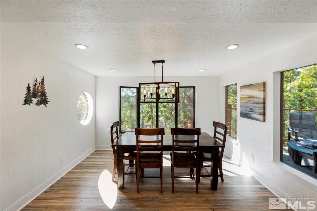 116 B Snowbird Court, Unit B Stateline, NV 89449 - Photo 8 of 40 a view of a dining room with furniture window and wooden floor