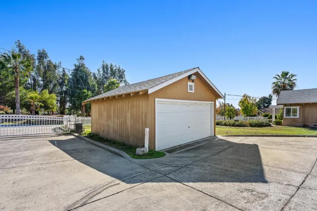 a view of a house with a yard and garage