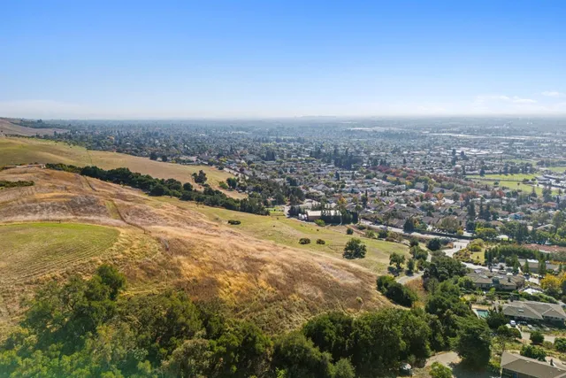 an aerial view of residential building and ocean view in back