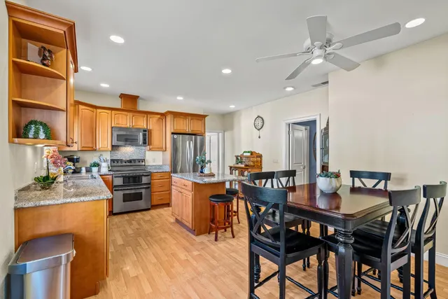 a kitchen with stainless steel appliances granite countertop a stove a sink and a microwave