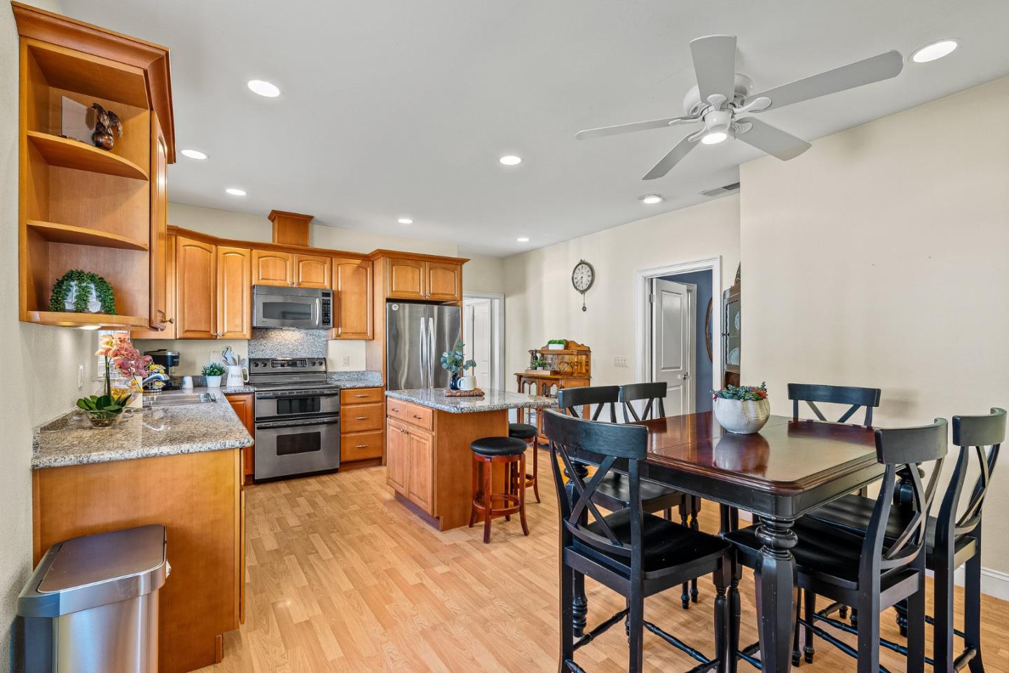 1995 Old Calaveras Road Milpitas, CA 95035 - Photo 40 of 53 a kitchen with stainless steel appliances kitchen island granite countertop a table chairs stove and refrigerator