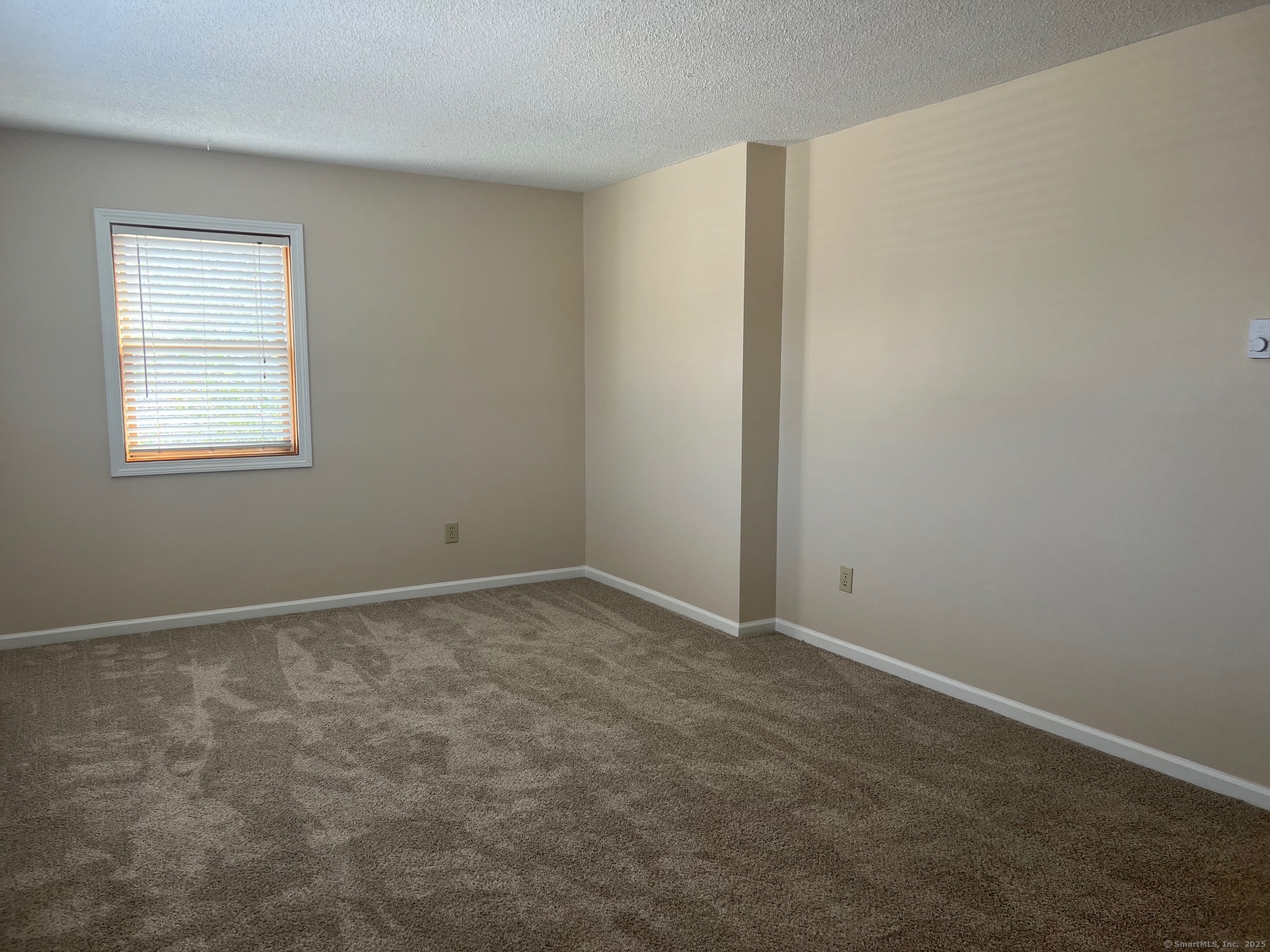 21 Prospect Street, Unit 1 Torrington, CT 06790 - Photo 5 of 13 an empty room with a window