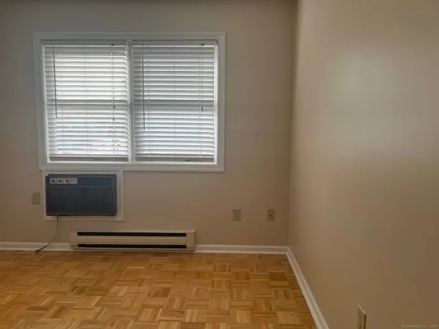 a view of a livingroom with an empty space and a window