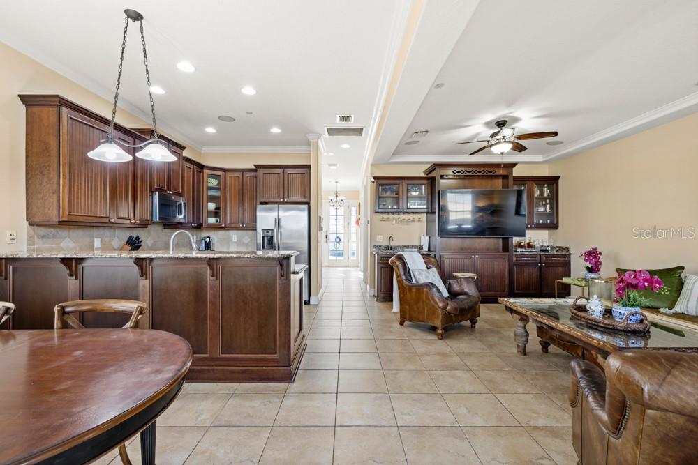 7423 Excitement Drive Reunion, FL 34747 - Photo 15 of 99 a kitchen with stainless steel appliances granite countertop a sink refrigerator and cabinets