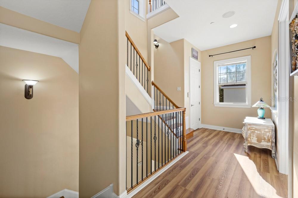 7423 Excitement Drive Reunion, FL 34747 - Photo 21 of 99 a view of a hallway with bedroom and wooden floor